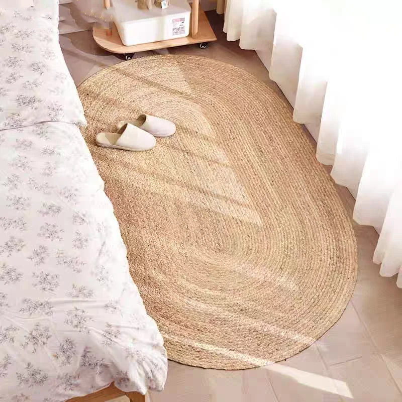 oval woven carpet beside bed cozy bedroom setup